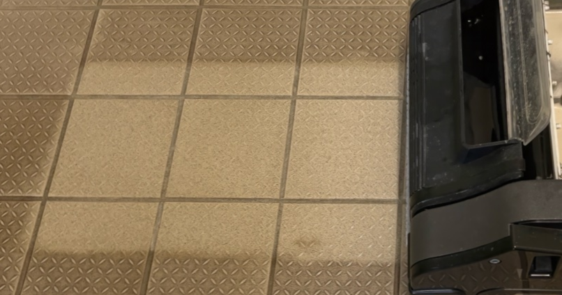 commercial floor scrubber is cleaning safety tile floor
